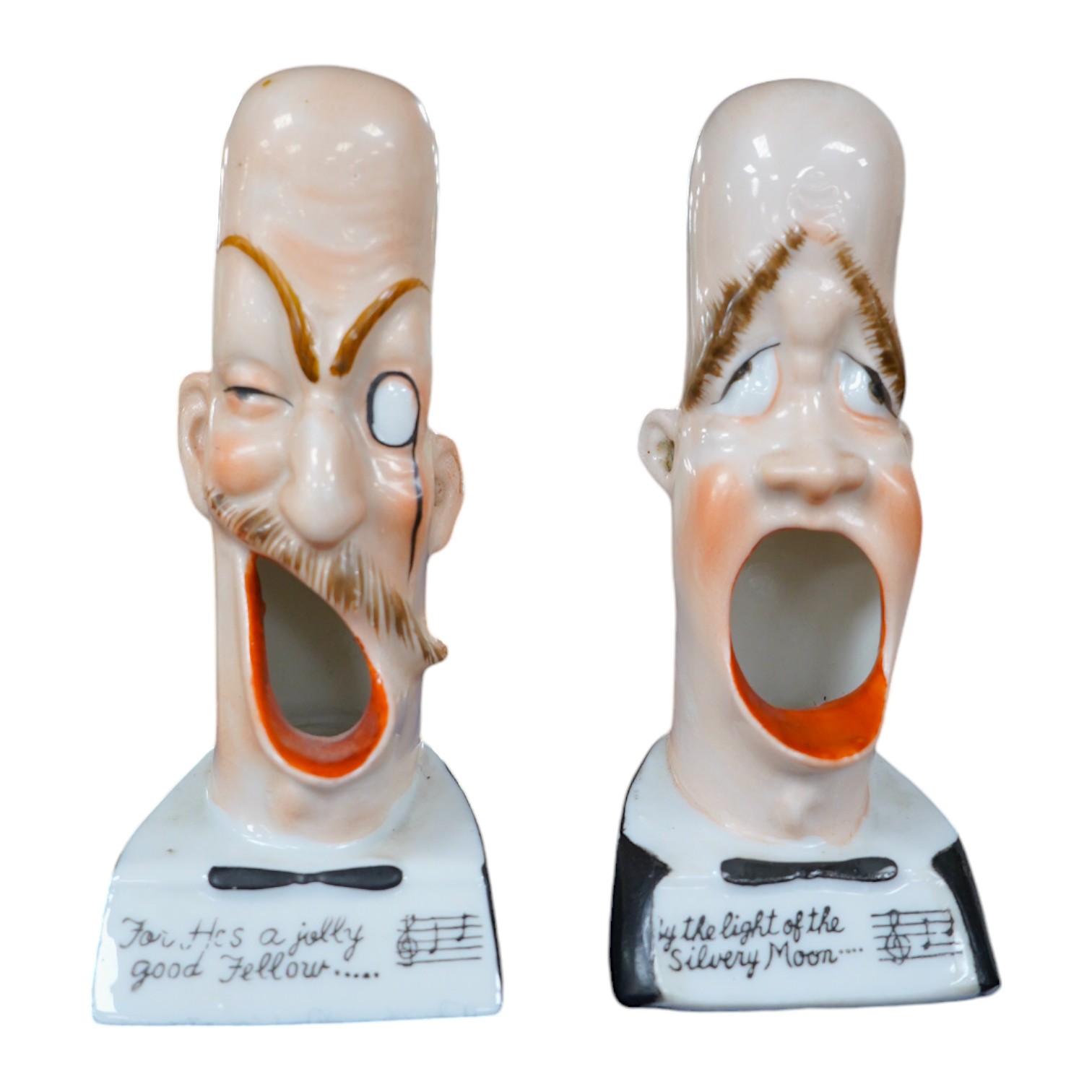 Two Vintage Schafer & Vater Ceramic Smoking Head ashtrays; 'He's A Jolly Good Fellow' and 'Light of the Silvery Moon', 13.5cm high. Condition - good